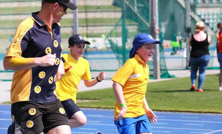 Students and adults race against eachother at Sports Carnival 2018